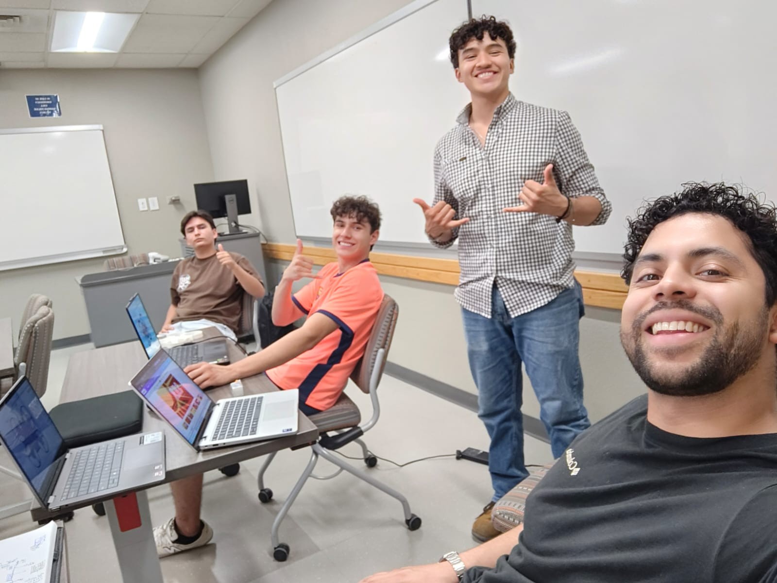 S.U.N. members collaborating around laptops